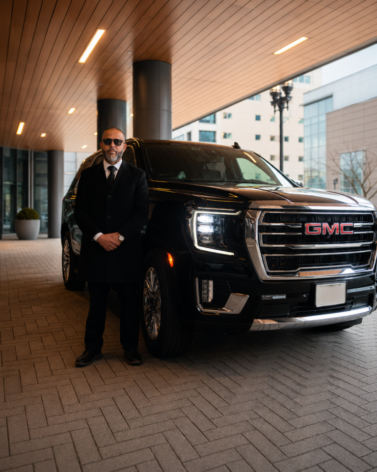 Professional chauffeur with luxury black SUV for Boston airport car service